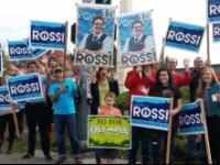 People waving signs for Marco Rossi to be elected mayor of Olympia, Washington